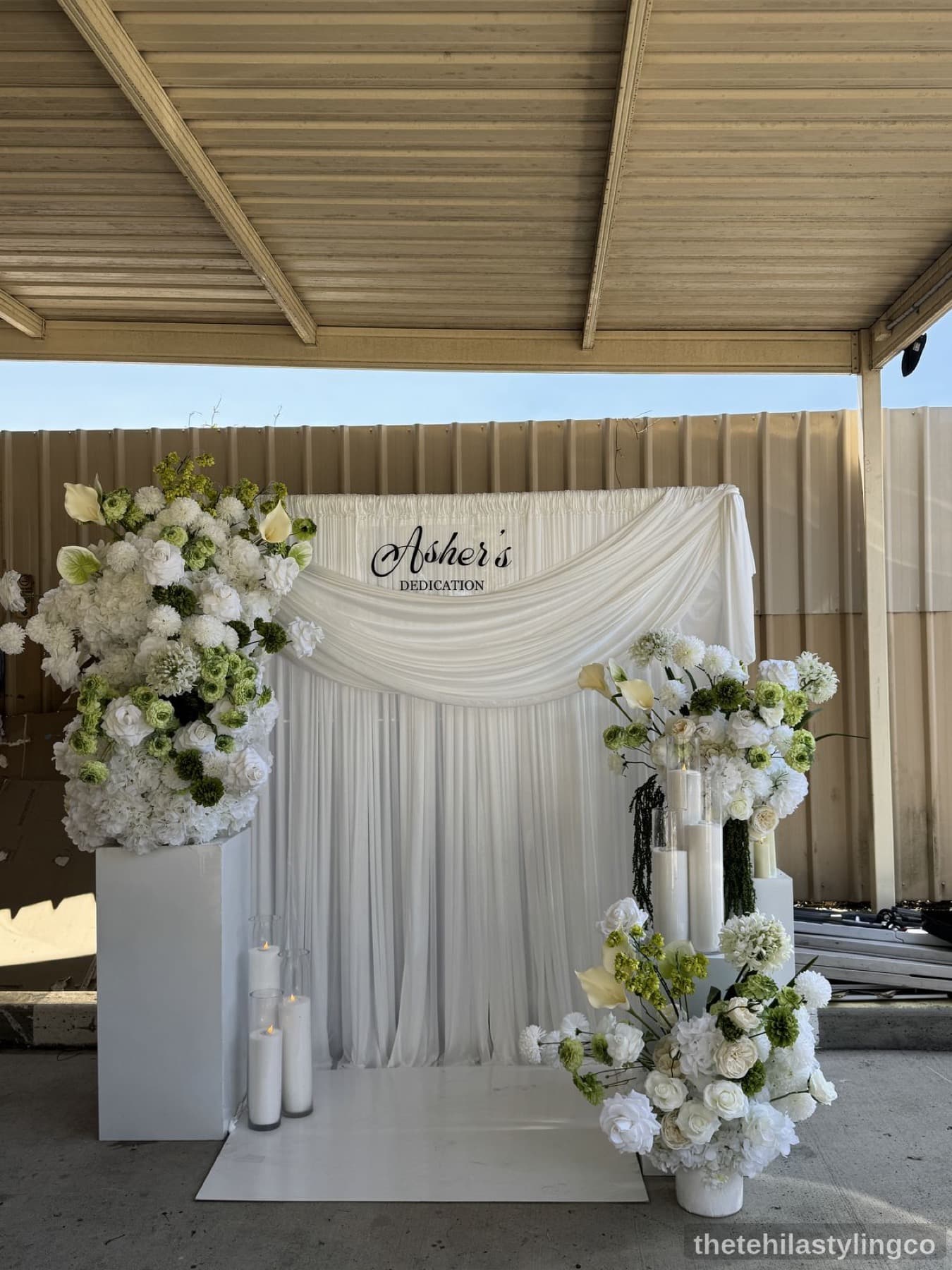 White and green floral dedication backdrop
